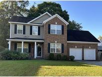 Brick two-story house with a two-car garage and well-maintained lawn at 170 Willowbend Ln, Summerville, SC 29485