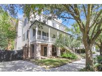 Two-story home with a large front porch at 64 Warren St, Charleston, SC 29403