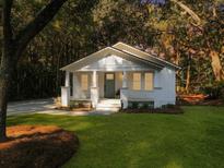 Charming white cottage with front porch and landscaping at 920 Simmons Ave, Summerville, SC 29483