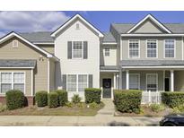 Two story townhome with neutral siding and landscaping at 102 Woodward Rd, Goose Creek, SC 29445