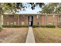 Brick apartment building with walkway and landscaping at 21 Rivers Point Row # 4B, Charleston, SC 29412