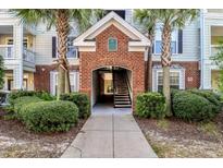 Brick building entrance with stairs and landscaping; inviting and well-maintained at 45 Sycamore Ave # 637, Charleston, SC 29407