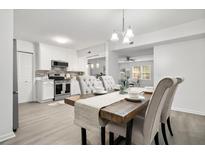 Bright dining area with farmhouse table and adjacent kitchen at 2150 Spoleto Ln # H7, North Charleston, SC 29406