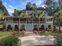 Two-story home with wrap-around porch and palm trees at 102 Flud St, Summerville, SC 29483