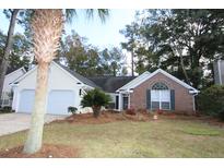 Brick and shingle exterior of charming house with two-car garage and landscaped lawn at 110 Smithfield Ave, Summerville, SC 29485