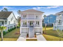 Two-story light purple house with white trim, double garage, and front porch at 2312 Bucktail Ct, Mount Pleasant, SC 29466