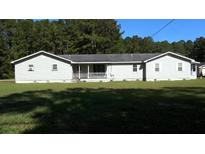 Ranch-style home with gray siding, white trim, and a covered porch at 8266 N Highway 17, McClellanville, SC 29458