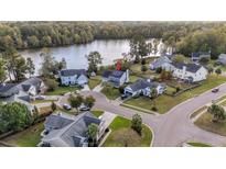 Aerial view of house with solar panels and lakefront lot at 417 Crystal Oaks Ln, Moncks Corner, SC 29461