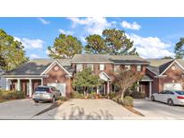 Brick townhouse with two-car driveway and landscaping at 110 Tuscany Ct, Ladson, SC 29456