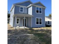Two-story house with gray siding, white trim, and a covered porch at 1725 W Avalon Cir, Charleston, SC 29407