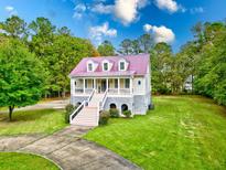 Two-story house with a metal roof, porch and stone accents at 147 Madison Brooke Ln, Summerville, SC 29486