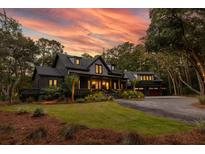 Two-story home with modern farmhouse exterior, charming porch and landscaping at 4028 Gnarled Oaks Ln, Johns Island, SC 29455