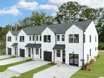 Exterior view of modern townhouses with white siding and black trim at 345 Bremerton Dr, Goose Creek, SC 29445