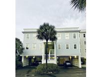 Two-story building with light blue siding and parking underneath at 1665 A Marsh Harbor Ln, Mount Pleasant, SC 29464
