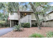 Exterior view of a charming two-story house with lush landscaping at 1111 Summerwind Lane, Seabrook Island, SC 29455