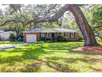 Brick ranch home with large tree and swing at 925 Center St, Mount Pleasant, SC 29464