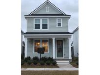 Two-story house with gray siding, dark green door, and landscaping at 331 Trailmore Ln, Summerville, SC 29486