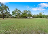 Spacious lot with a mobile home in the middle of a grassy field at 640 Country Pond Ln, Cross, SC 29436