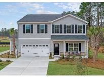 Two-story home with gray siding, black shutters, and porch at 205 Torslanda Ln, Summerville, SC 29486