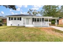 One-story house with carport and white picket fence at 7049 Kenneth Dr, North Charleston, SC 29406