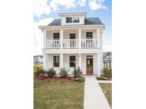Two-story white house with a front porch, landscaping, and walkway at 123 Cantona Dr, Summerville, SC 29483