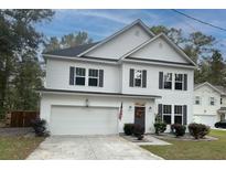 Two-story home with white siding, a gray door, and a two-car garage at 154 Pecan Dr, Summerville, SC 29483