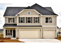Two story house with a three car garage and neutral colors at 153 Seaton Street, Summerville, SC 29486