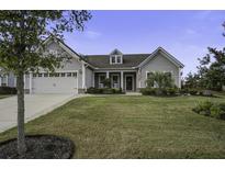 Gray two-story home with front porch, two-car garage, and landscaped yard at 119 Camelia Park Ln, Summerville, SC 29486