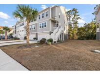 Three story townhome with attached garage and front yard at 139 Winding River Dr, Johns Island, SC 29455
