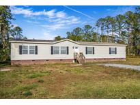 Single-story home with brick accents and a landscaped yard at 122 Rambo Dr, Summerville, SC 29483
