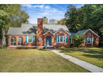 Brick home with blue shutters, landscaped lawn, and walkway at 112 Minus St, Saint George, SC 29477