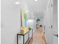 Bright hallway with light wood floors and shiplap walls at 1323 Pelican Watch Villas, Seabrook Island, SC 29455