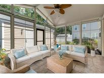 Bright sunroom with wicker furniture and light flooring at 1751 Bee Balm Rd Rd, Johns Island, SC 29455