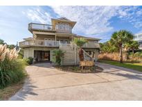 Two-story beach home with multiple decks and a spacious driveway at 202 Mary St, Edisto Island, SC 29438