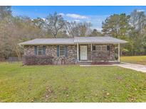 Brick ranch house with gray metal roof and small front porch at 313 Fairlawn Dr, Moncks Corner, SC 29461
