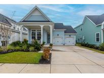 Charming light blue house with a two-car garage and landscaped front yard at 104 True Blue, Summerville, SC 29486