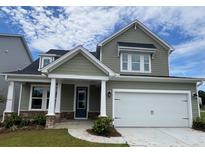 Two-story house with gray siding, white garage door, and stone accents at 137 Winding Grove Ln, Moncks Corner, SC 29461