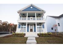 Two-story blue house with white trim, porch, and landscaping at 2089 Blue Bayou Blvd, Johns Island, SC 29455