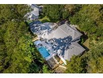 Aerial view of home showcasing pool, patio, and lush landscaping at 371 Live Palmetto Bluff, Mount Pleasant, SC 29464