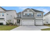 Two-story gray house with a two car garage and manicured lawn at 109 Seaton St, Summerville, SC 29486