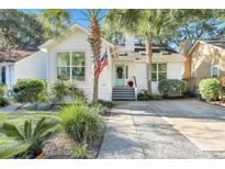 Charming white house with a green door, palm trees, and a spacious driveway at 1515 Barquentine Dr, Mount Pleasant, SC 29464