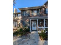 Brick townhouse with front porch and landscaping at 403 Reserve Way, Summerville, SC 29485