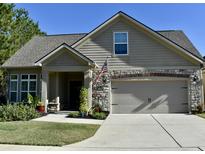 Beautiful two-story house with a stone facade and a two-car garage at 404 Claymoor Village Ln, Summerville, SC 29486
