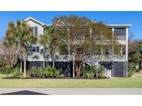 Two-story home with wrap-around porch, mature trees, and landscaped lawn at 780 Post Oak Dr, Mount Pleasant, SC 29464