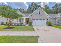 Brick and shingle home with a two-car garage and manicured lawn at 1103 Old Field Dr, Summerville, SC 29483