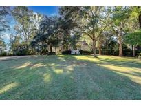Beautiful home nestled on a spacious lot with mature trees and lush lawn at 4415 Lord Proprietors Rd, Hollywood, SC 29449