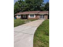 Brick ranch home with a long driveway and mature trees at 4450 Hardwood St, Ladson, SC 29456