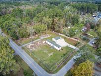 Aerial view of a single-wide mobile home on a spacious lot with mature trees at 113 Hill Drive, Summerville, SC 29483