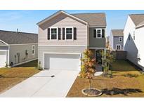 Two-story house with beige siding, gray roof, and a two-car garage at 126 Sunray Ln, Summerville, SC 29486