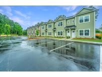 Exterior view of townhomes with ample parking at 1504 Twin Rivers Dr # 40, Wando, SC 29492